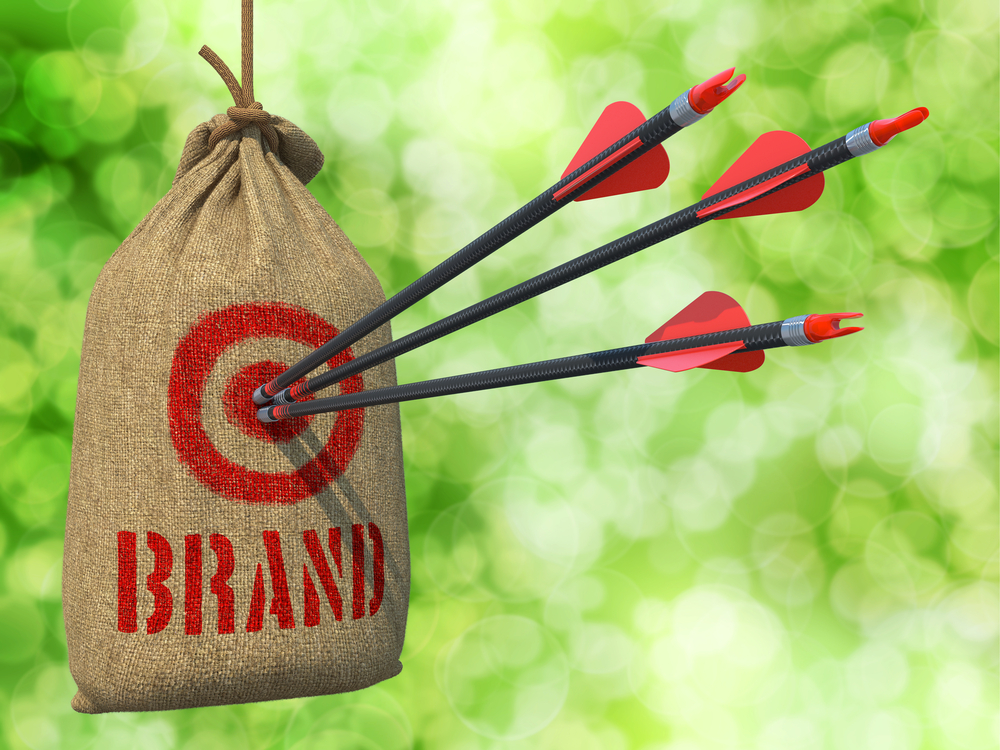 Brand - Three Arrows Hit in Red Target on a Hanging Sack on Green Bokeh Background.